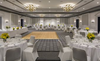 a large , elegant banquet hall with white chairs and tables set up for a formal event at InterContinental Sydney Double Bay, an IHG Hotel