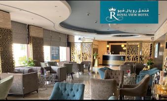 a luxurious hotel lobby with various seating options , including chairs and couches , and a reception desk at Royal View Hotel