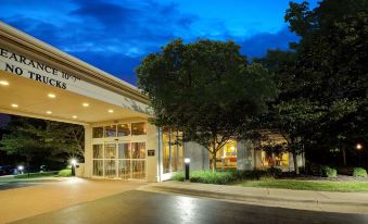 "a large building with a sign that reads "" conrad hotels "" prominently displayed on the front of the building" at Hilton Garden Inn Chesterton