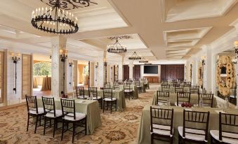 a large banquet hall with multiple dining tables and chairs , all set up for an event at Rancho Valencia Resort and Spa