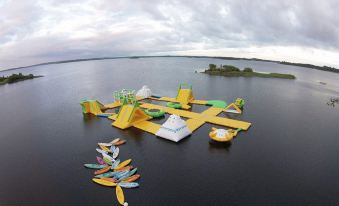 an aerial view of a large body of water with various water toys floating on it at Prince of Wales Hotel