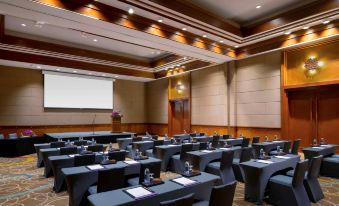 A spacious room is set up with rows of tables for an event or function at Novotel Phuket Resort