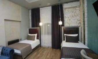 The room includes two beds and an attached bathroom, similar to other hotel rooms at Mia Milano Hotel
