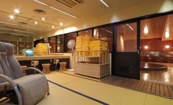a room with a large window and a wooden bench , featuring stacks of yellow items at Fukui Hotel