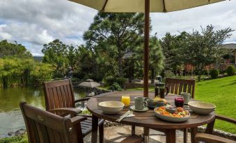 a wooden dining table set up for breakfast , with a variety of food items and utensils placed on the table at Koanze Luxury Hotel & Spa