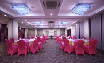 a large conference room with multiple tables and chairs arranged for a meeting or event at favehotel Langko Mataram - Lombok