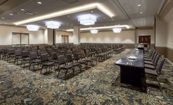 a large conference room with rows of chairs arranged in a semicircle , and a podium at the front of the room at Holiday Inn Chicago North-Evanston, an IHG Hotel