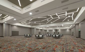 a large conference room with multiple rows of chairs arranged in a semicircle , and a projector mounted on the wall at Courtyard Austin Pflugerville and Pflugerville Conference Center