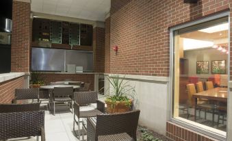 an outdoor dining area with a variety of chairs and tables , providing a pleasant atmosphere for guests at TownePlace Suites by Marriott Champaign