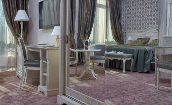 a luxurious hotel room with a large mirror on the wall , a bed , a desk , and a couch at Savoy Hotel