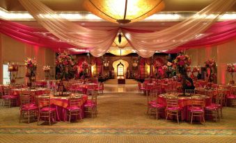 a large banquet hall with multiple dining tables and chairs arranged for a wedding reception at Hilton Miami Airport Blue Lagoon