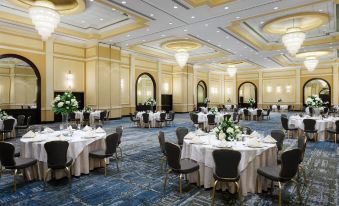 a large banquet hall with multiple round tables and chairs arranged for a formal event at Delta Hotels Woodbridge
