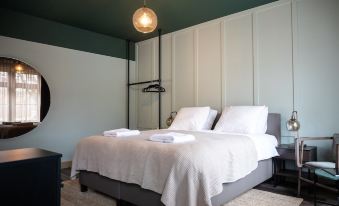 a bedroom with two white beds , one on top of the other , and a closet in the background at Mr Lewis Haarlem