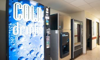 "a vending machine with a large screen that says "" cold drink "" and an ice machine" at Executive Inn