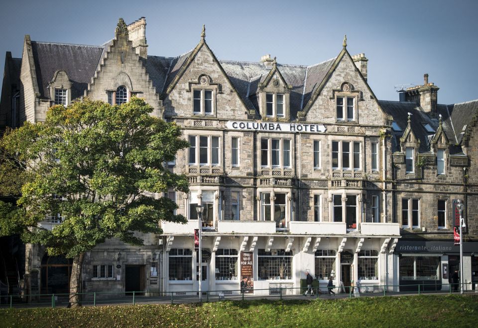 "a large stone building with a sign that reads "" columbia hotel "" on the front of the building" at Columba Hotel Inverness by Compass Hospitality