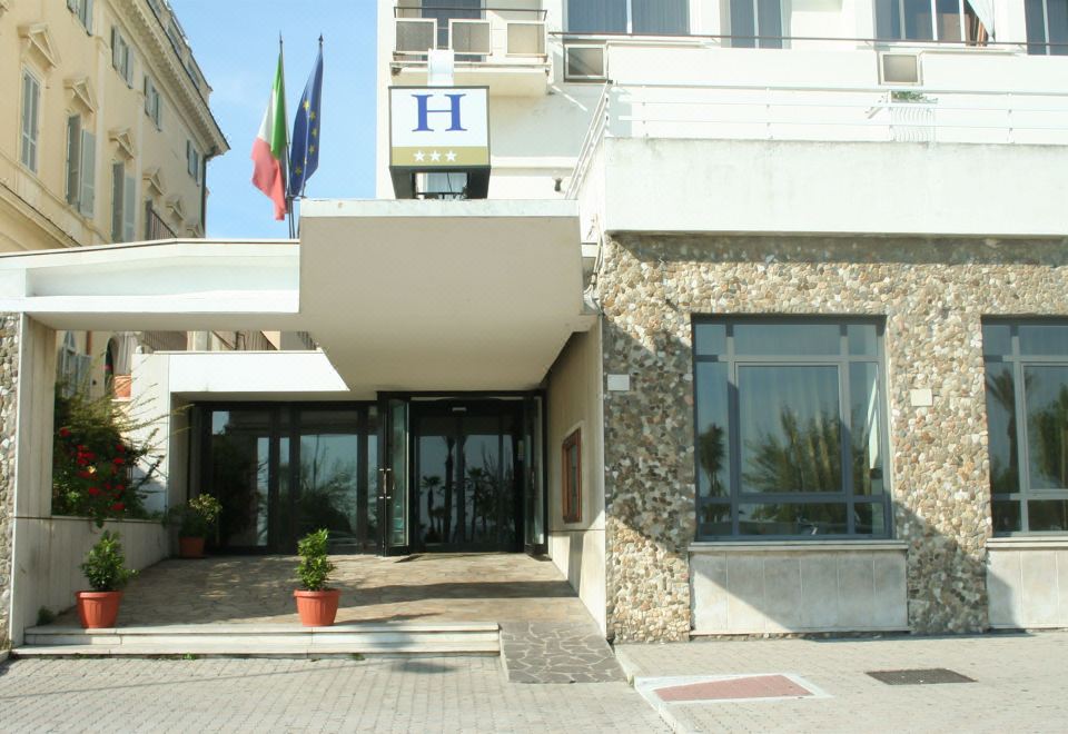 a hotel entrance with a sign above the door , indicating that it is a hotel at Hotel Mediterraneo