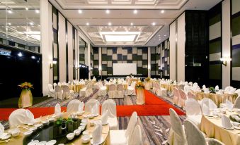 a large banquet hall with multiple tables and chairs set up for a formal event at Thistle Port Dickson Resort