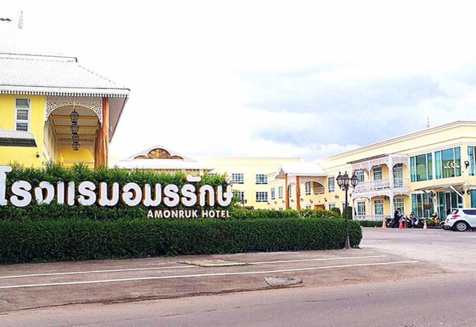 "a large building with the sign "" suvasun "" on it , surrounded by greenery and a street" at Amonruk  Hotel 2