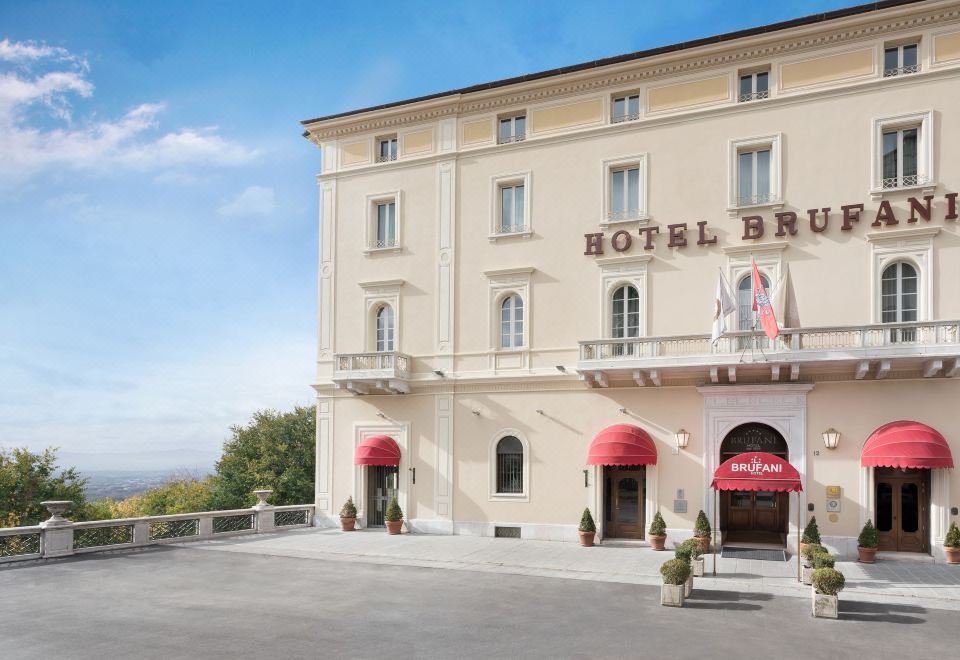 "a large hotel building with a red awning and the words "" hotel brio "" written on it" at Sina Brufani