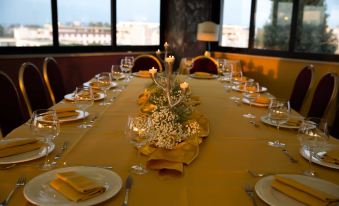a long dining table set for a formal event , with multiple chairs arranged around it at Park Hotel