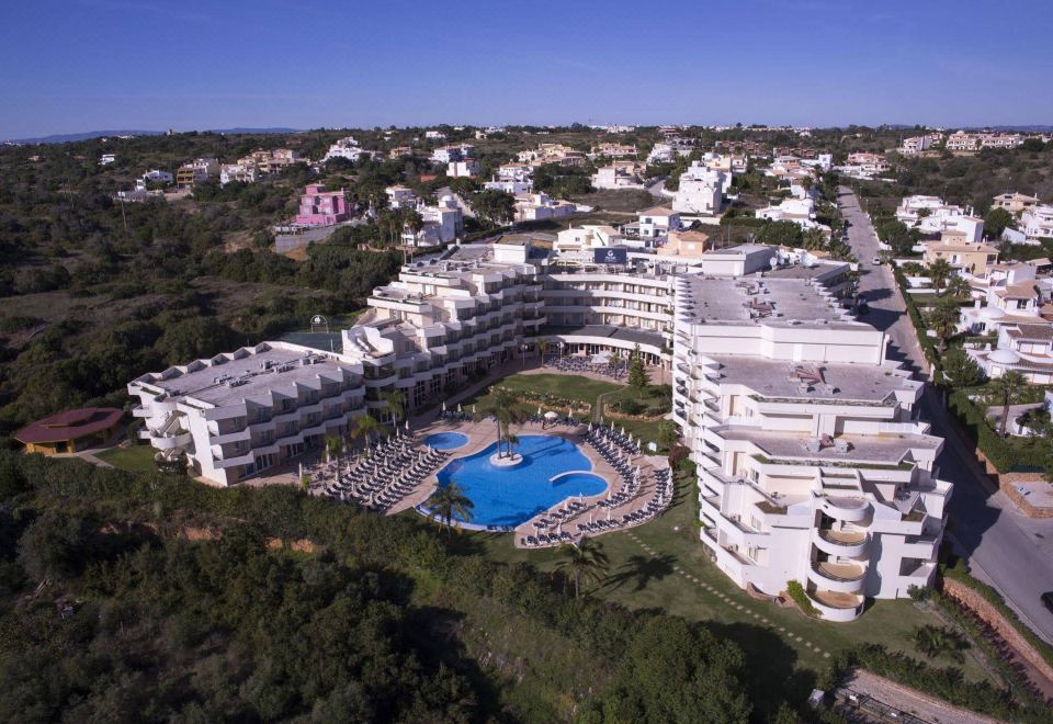 aerial view of a large resort complex with multiple buildings , a swimming pool , and lush greenery at Vila Gale Nautico
