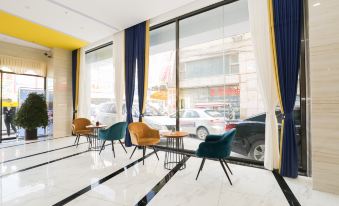 The room features large windows and chairs in the middle, creating an open concept space at Muge Hotel