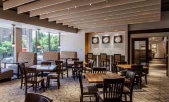 a large dining room with wooden tables and chairs arranged for a group of people to enjoy a meal together at Holiday Inn Chicago North-Evanston, an IHG Hotel