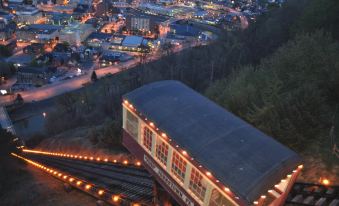 aerial view of a red and white train on a track at night , surrounded by city lights at Holiday Inn Johnstown-Downtown