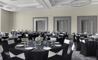 a large dining room with round tables covered in black tablecloths , chairs , and a white centerpiece at Courtyard Dallas Flower Mound