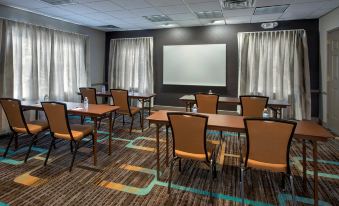 a conference room with several chairs arranged in rows and a whiteboard on the wall at Residence Inn Cranbury South Brunswick