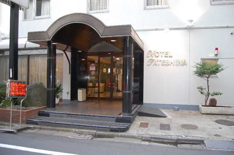 The entrance to a hotel on Main Street, featuring an exterior view and a sign displaying the street name at Hotel Tateshina