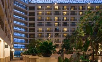 a modern hotel with a glass ceiling and large windows , allowing natural light to illuminate the interior at Hyatt Regency San Francisco Airport