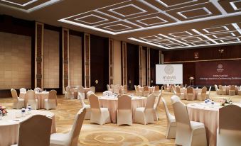 a large conference room with multiple tables and chairs arranged for a meeting or event at Merusaka Nusa Dua