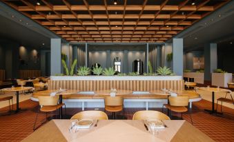 a modern restaurant with wooden tables and chairs , potted plants , and a bar area in the background at Pan Pacific Perth