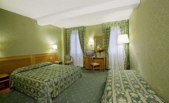 a hotel room with two beds , one on the left and one on the right side of the room at Hotel Nazionale