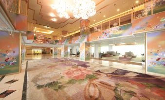 a large hotel lobby with a marble floor , a chandelier , and a mural on the wall at Hotel Mahoroba