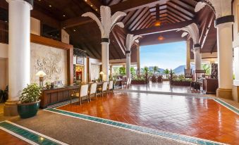The lobby and dining area are located in a spacious building with an open floor plan at Novotel Phuket Resort