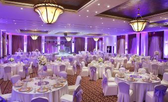 a large banquet hall with tables and chairs set up for a formal event , possibly a wedding reception at InterContinental Hotels Aqaba (Resort Aqaba)