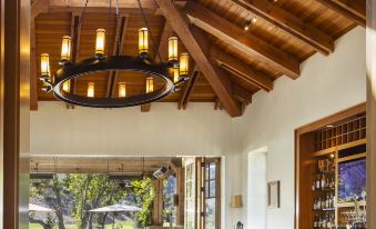 a dining room with wooden tables and chairs , as well as a chandelier hanging from the ceiling at CordeValle