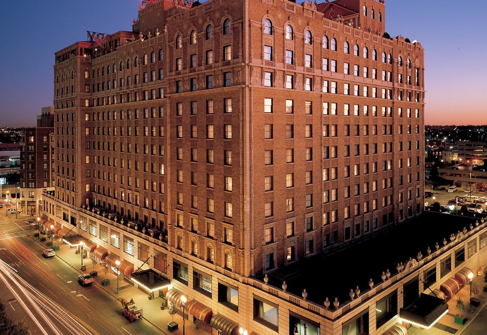 "a large brick building with a sign that reads "" hotel des artistes "" is lit up at night" at Peabody Memphis