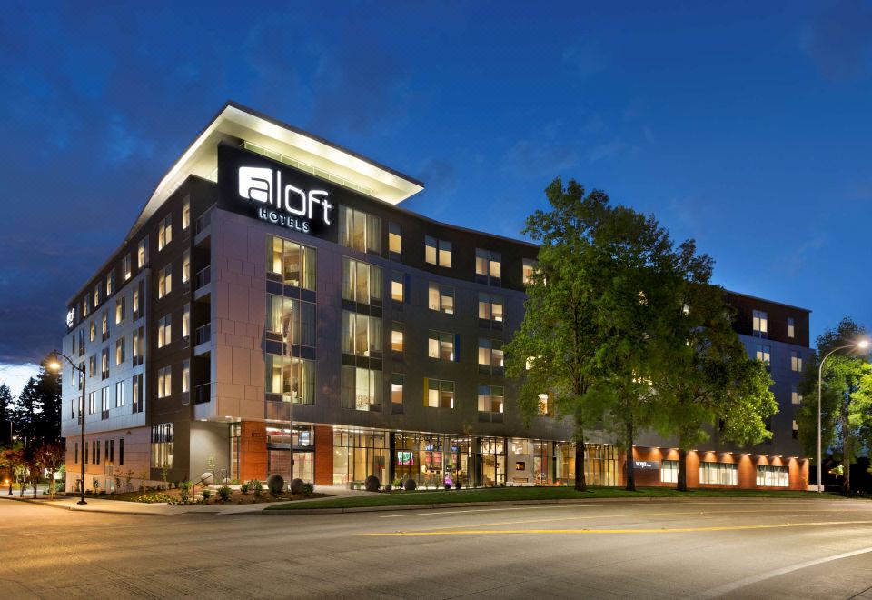 "a large building with the word "" idr "" on it is lit up at night , surrounded by trees and a street" at Aloft Hillsboro-Beaverton