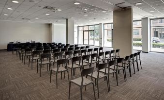 a large conference room with rows of chairs arranged in a semicircle , ready for a meeting at Inn Naples Airport