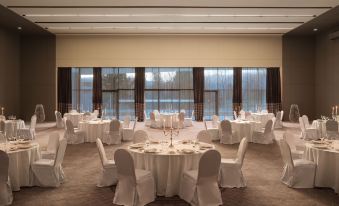 a large , empty conference room with multiple round tables set for a formal event or a wedding reception at Sheraton Dubrovnik Riviera Hotel