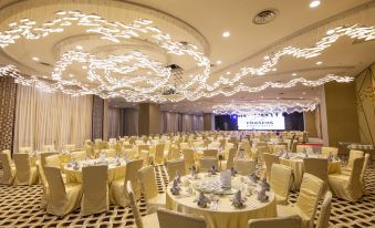 a large banquet hall with multiple round tables and chairs set up for a formal event at Fraser Place Puteri Harbour, Johor