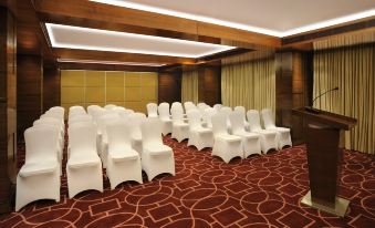 a conference room with rows of chairs arranged in a semicircle , ready for a meeting at Four Points by Sheraton Ahmedabad