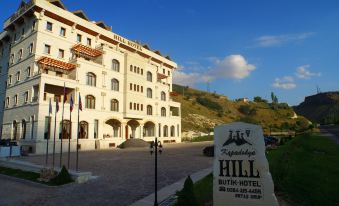 "a large white building with a sign that reads "" hotel "" in front of a hill" at Kapadokya Hill Hotel & Spa (12+)
