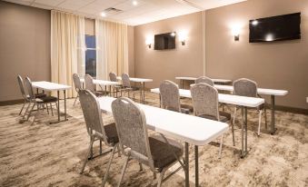 a conference room with multiple tables and chairs arranged for a meeting or training session at Best Western Plus Executive Residency Austin