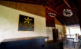 "a bar with a black counter and wooden beams , featuring a gold sign that says "" flora ""." at Aurora Resort Chiangdao