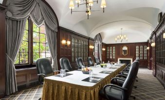 a large conference room with a long table and multiple chairs arranged for a meeting at Hilton Boston Park Plaza