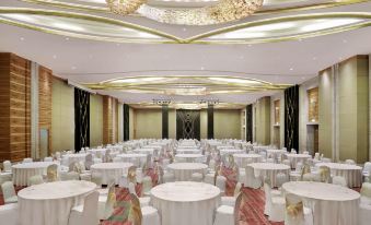 a large banquet hall with round tables and chairs set up for a formal event at Novotel Jakarta Mangga Dua Square